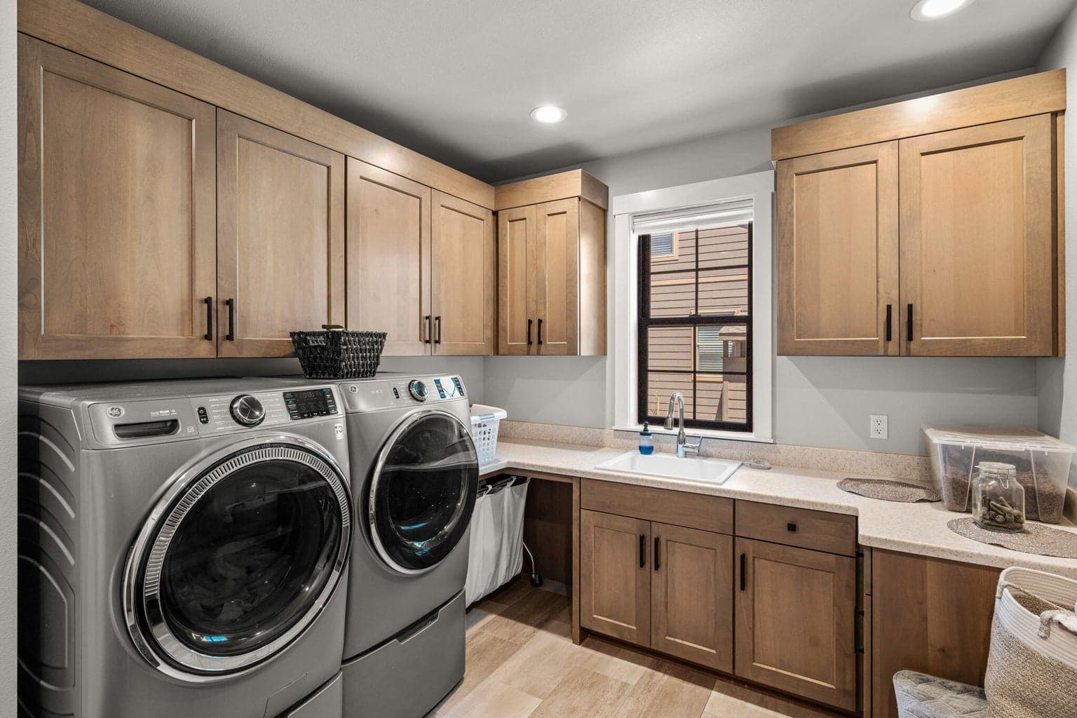 Large laundry room with extra cabinets and sink