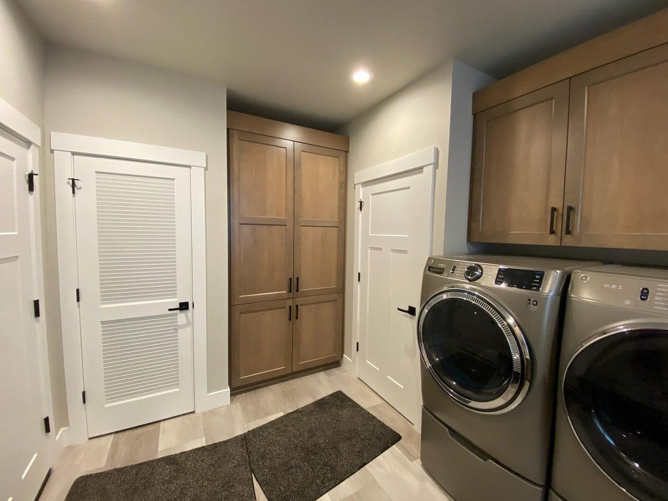 Laundry room with extra cabinets and closet for storage or beverage fridge.