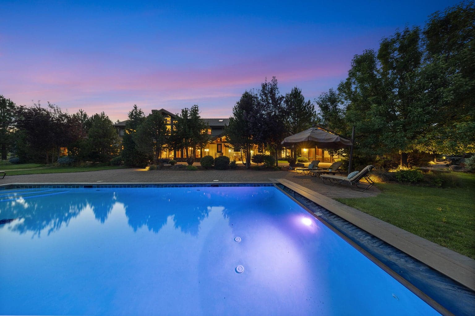 Luxury meets leisure in a heated, in-ground pool surrounded by expansive paver patios and breathtaking high-desert views.