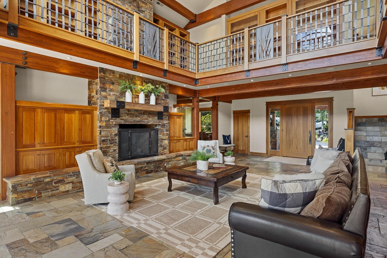 Volume and warmth combine in a great room that opens to an upper library—a space designed for both grand entertaining and quiet reflection.