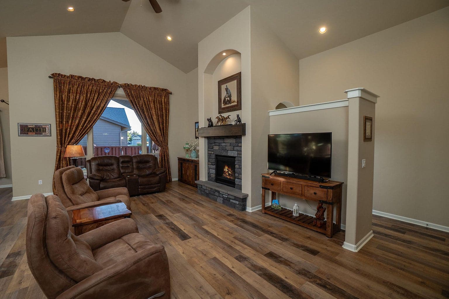 Natural gas fireplace with beautiful masonry, stained mantle, and hearth .