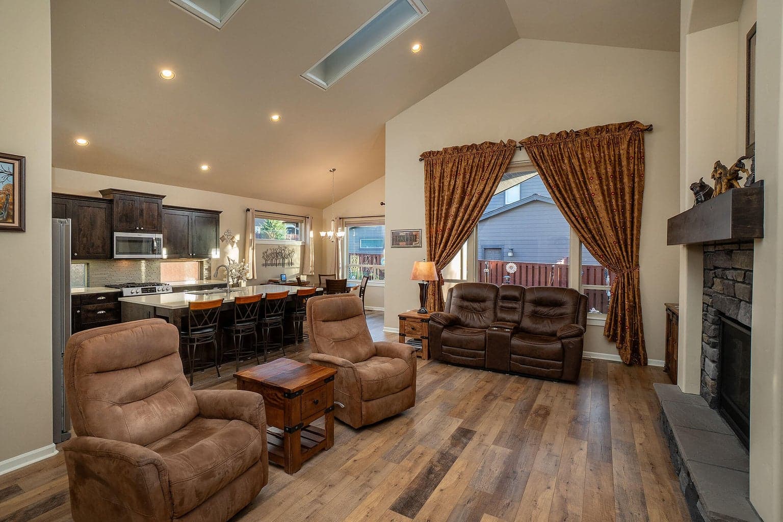 Greatroom with tall vaults and skylights. Skylights have remote controlled window coverings