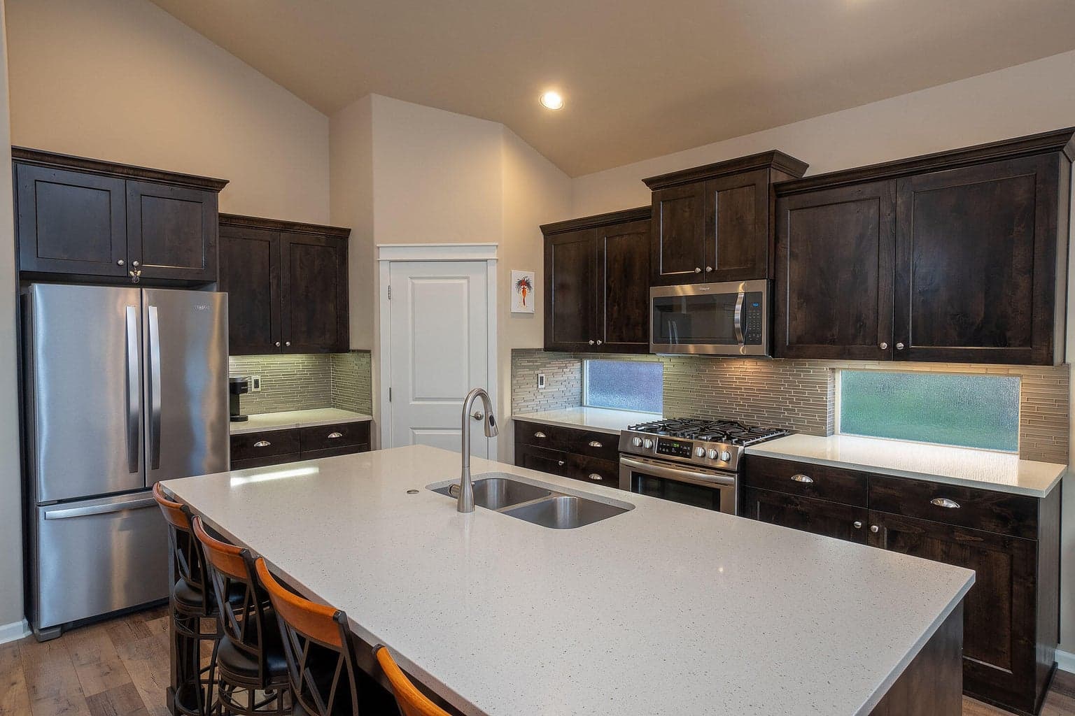 Kitchen has a large island of quartz, perfect for entertaining.