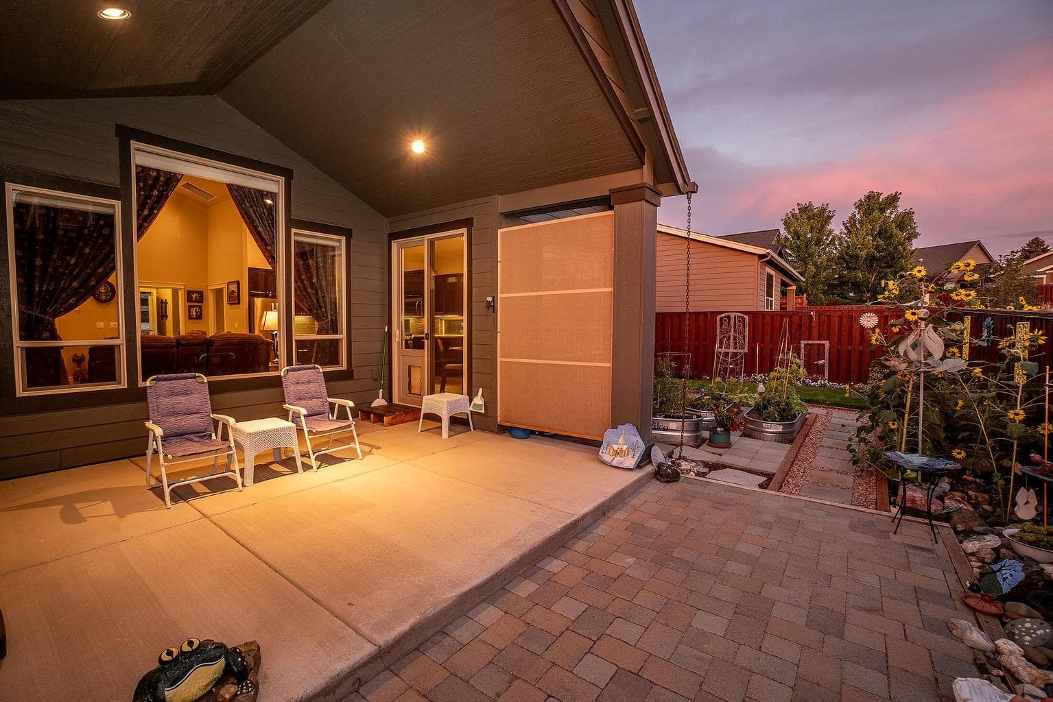 Covered rear patio with paver block extension.