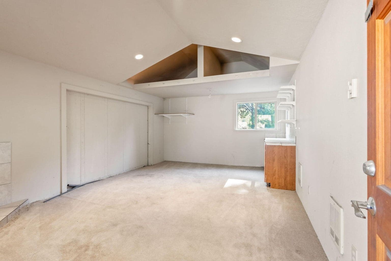 Sliding wall on left, counter/storage to right. Exterior water spigot located just outside the back wall with window.