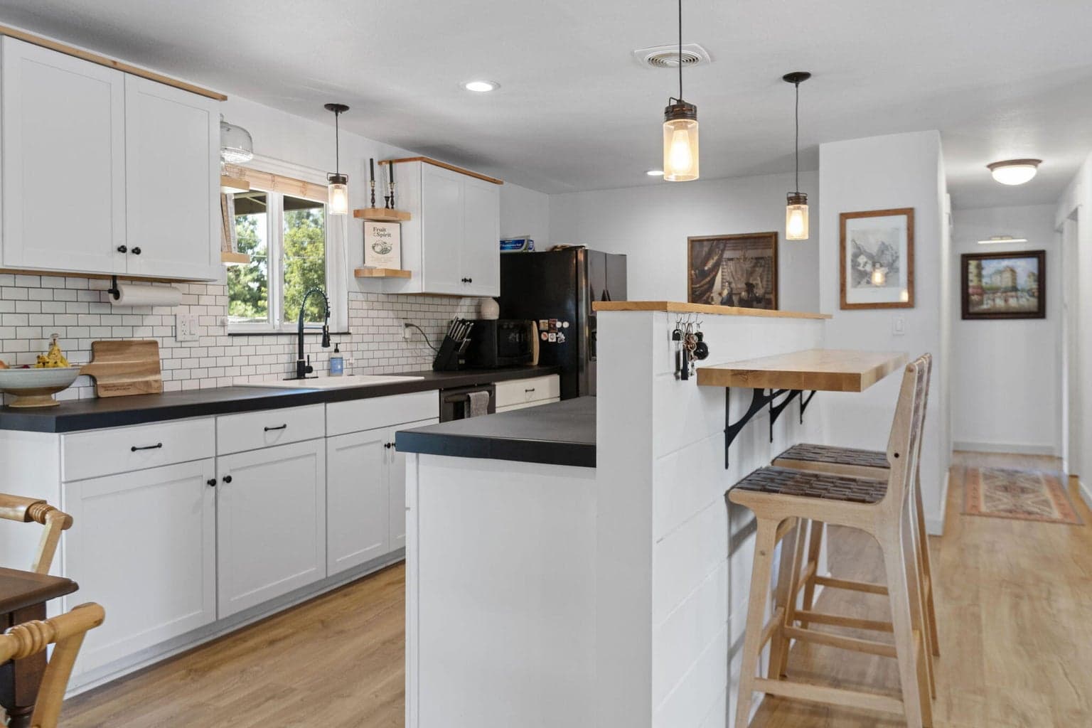 Nicely updated kitchen with 24” tiled countertops, stainless steel appliances, a coffee nook, and an under mount dark sink