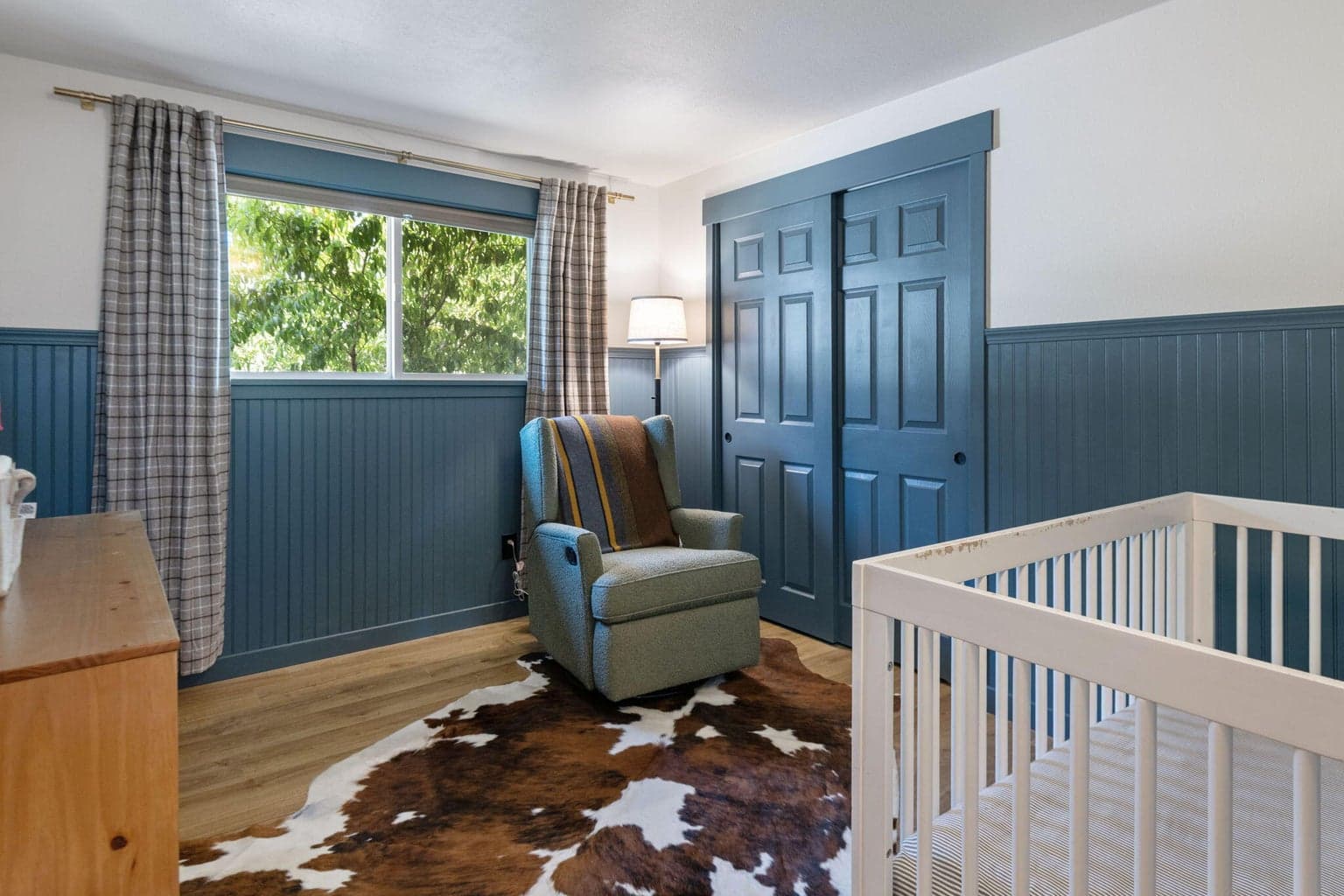 Guest bedroom number one with with wainscoting and fresh paint