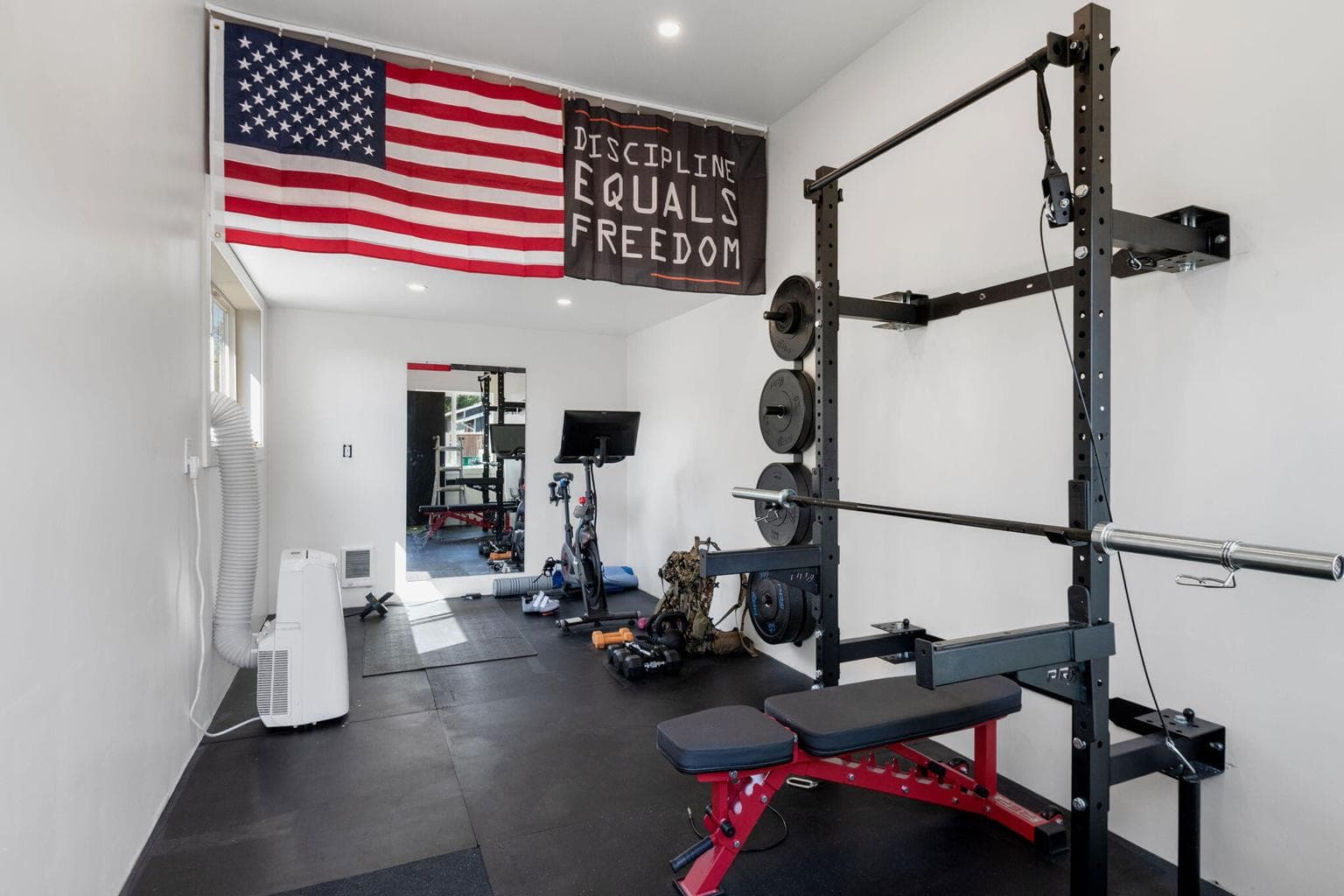 Interior of the detached 10X 20’ building. Additional storage on the shelves behind the flags.