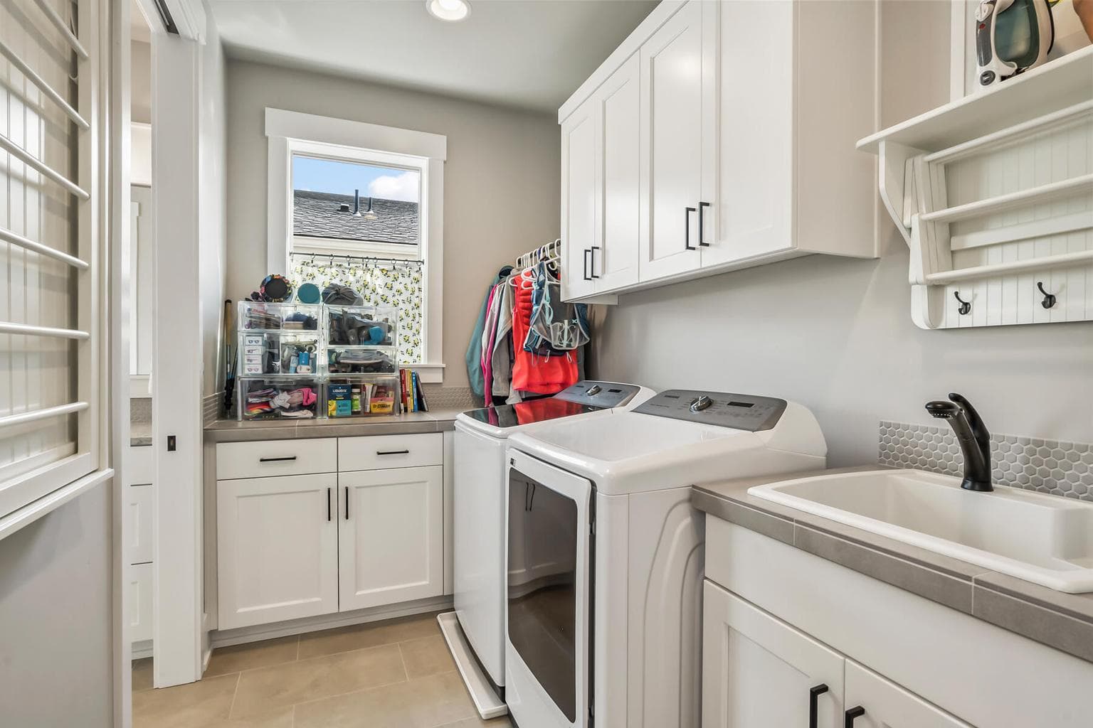 Laundry room accessible from hall or primary bath.