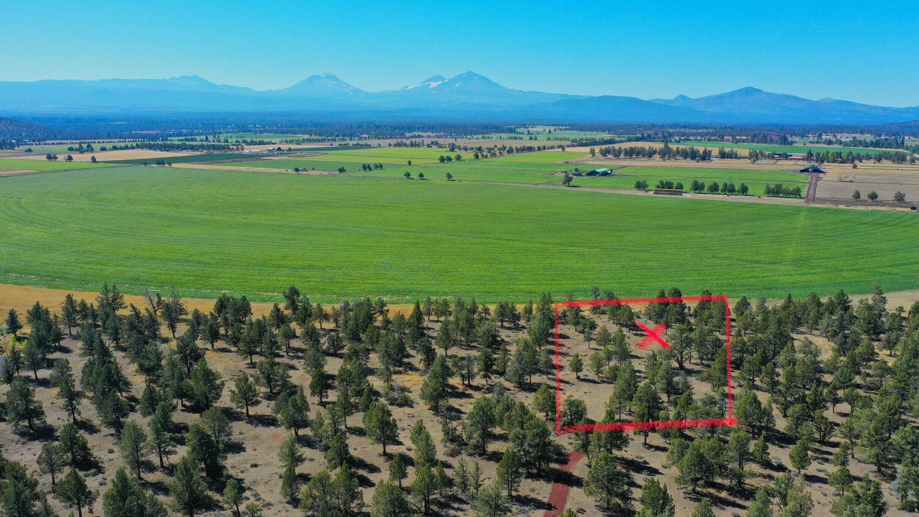 X marks the center of the parcel. Approximate parcel boundaries.