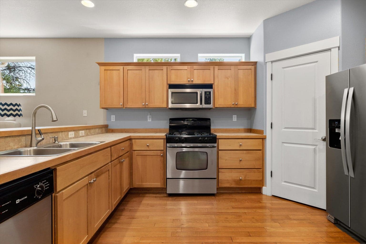 Kitchen with Stainless Steel appliances, hardwood floors and Corner Pantry