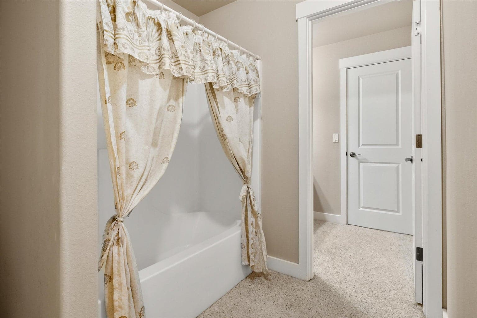 Tub between two rooms with sinks