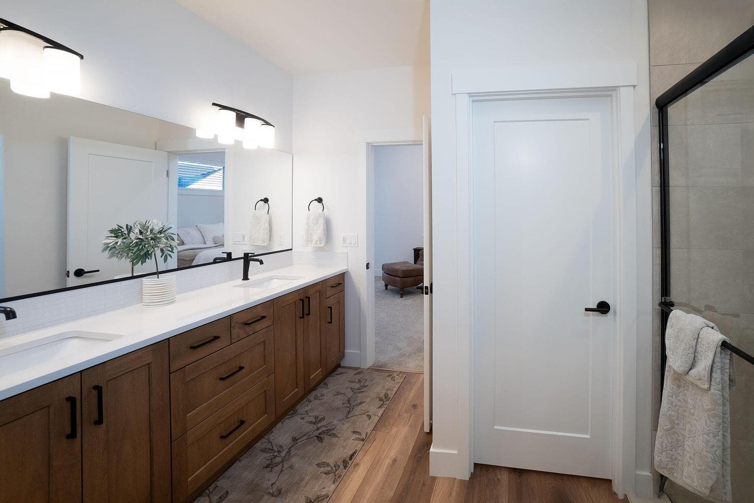 Primary suite bath is spacious having a tile shower, water closet and walk in closet.
