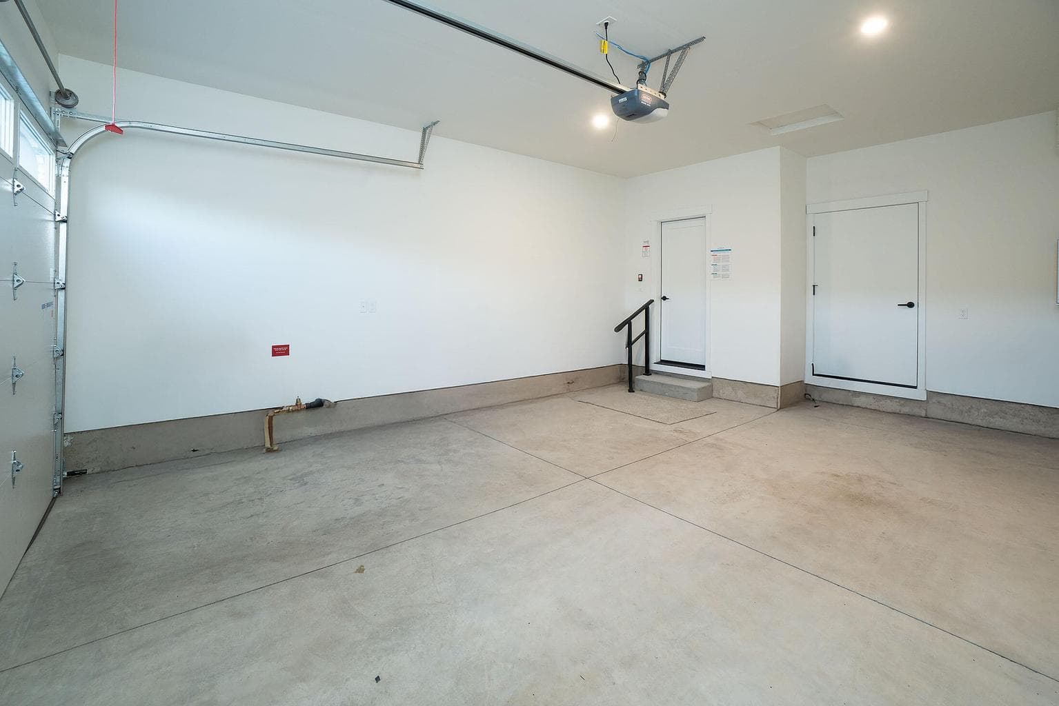 Garage with door opener and door to the yard.