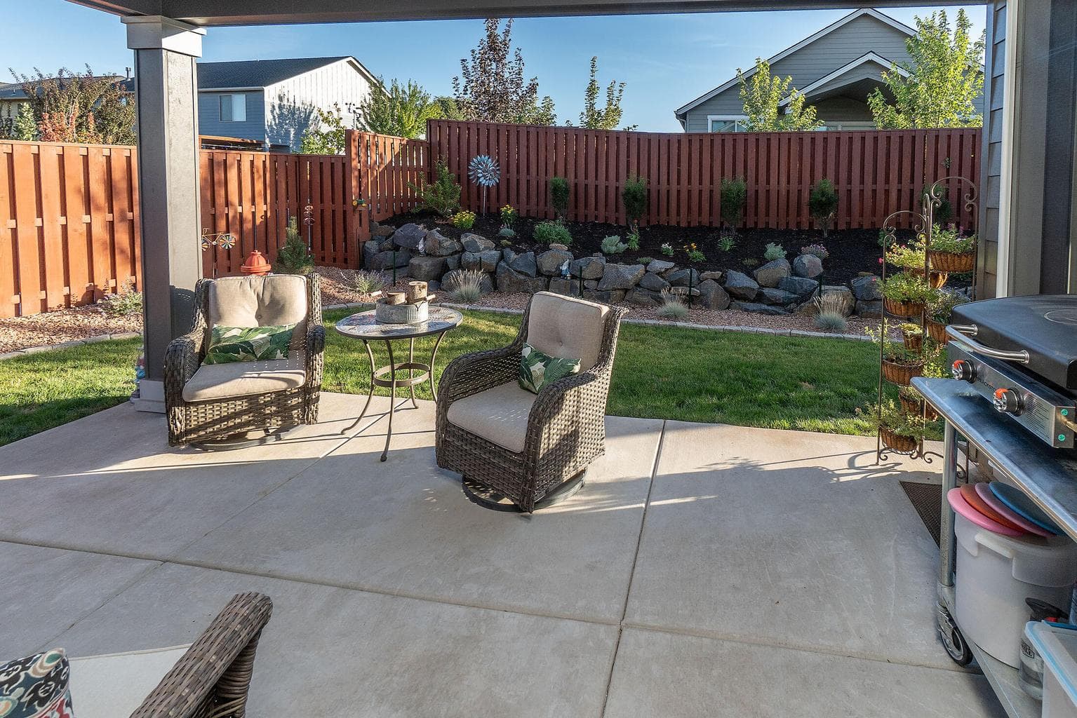 Private rear yard with large covered patio and beautiful landscaping