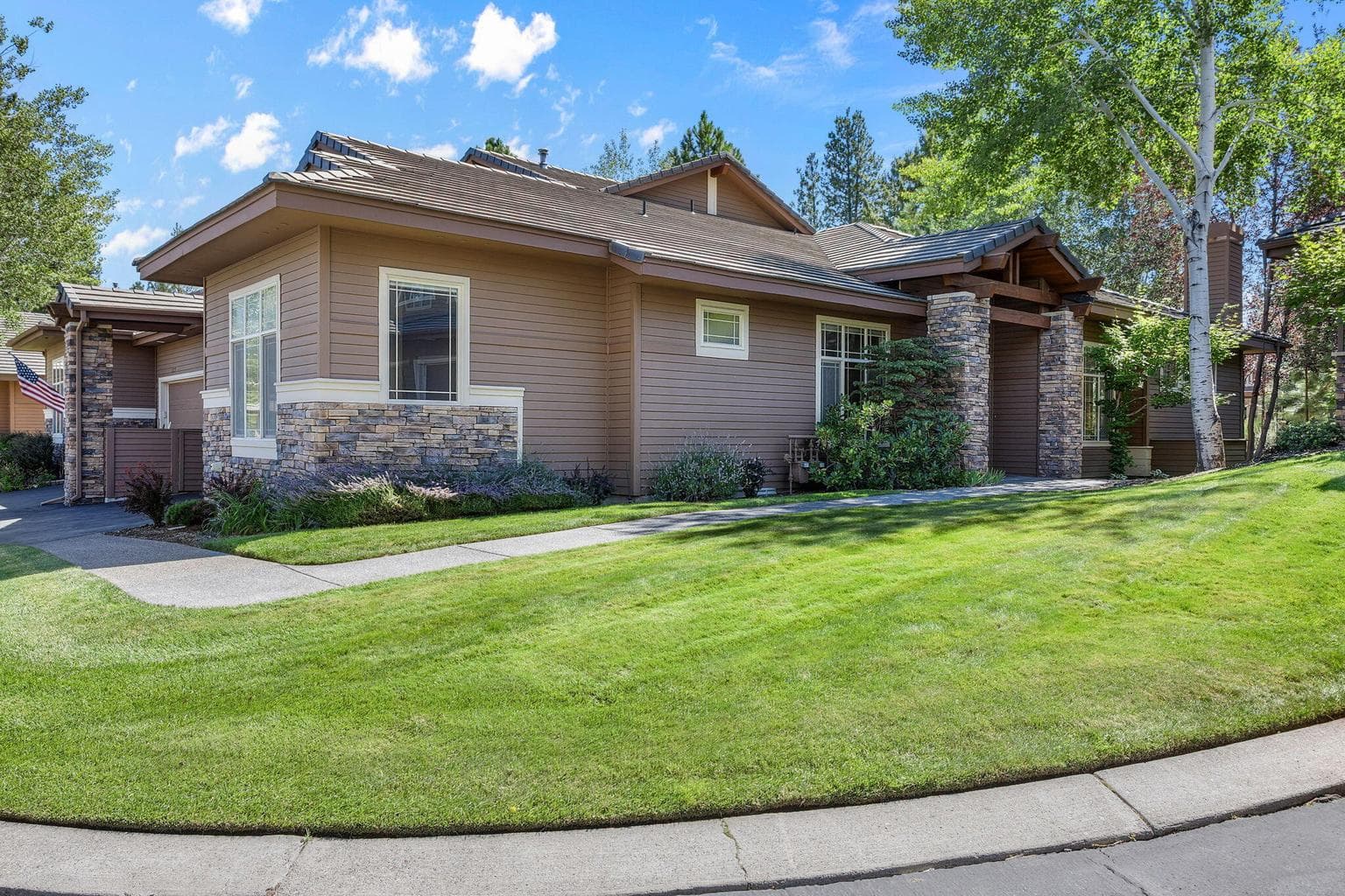 Pathway leading to the private entry. Double Car garage and additional guest parking nearby.