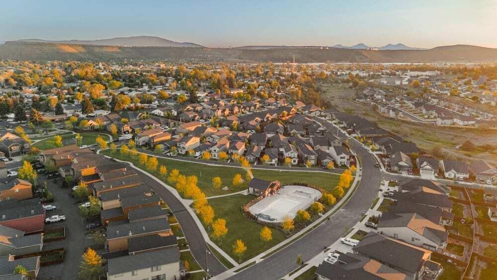 Ochoco Pointe community drone photo of park, pool, and neighborhood