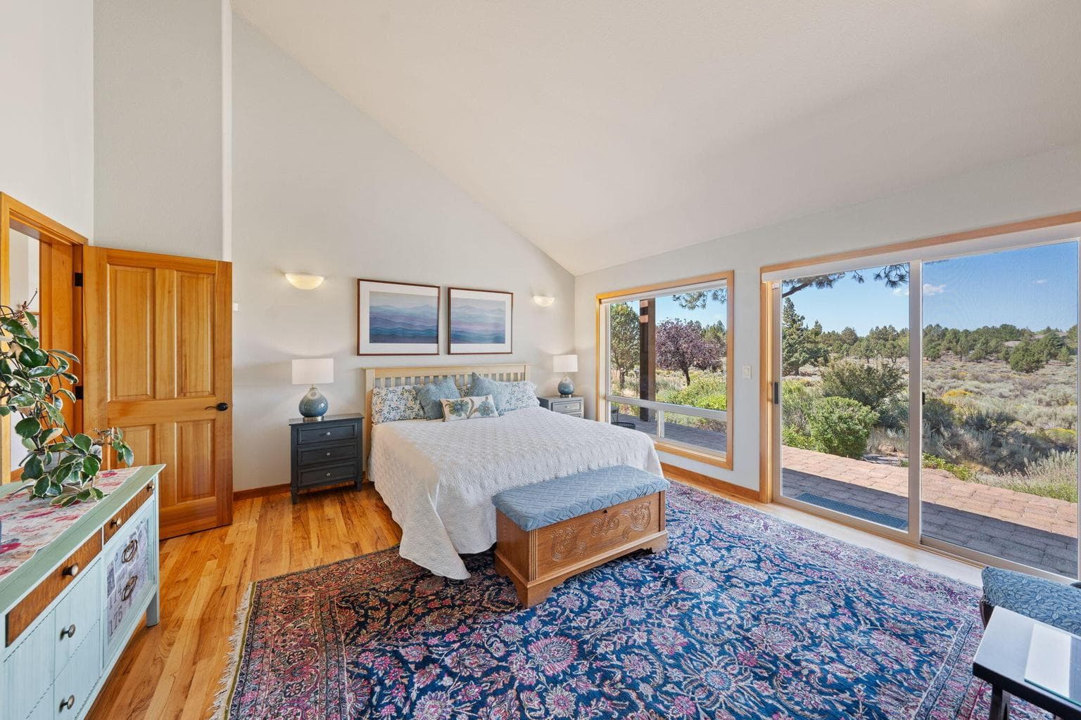 Primary bedroom is light and bright with vaulted ceiling
