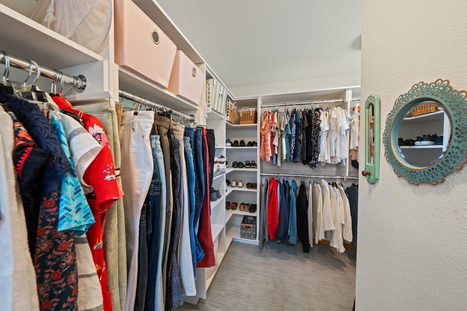 One of two walk in closets in the primary with natural light