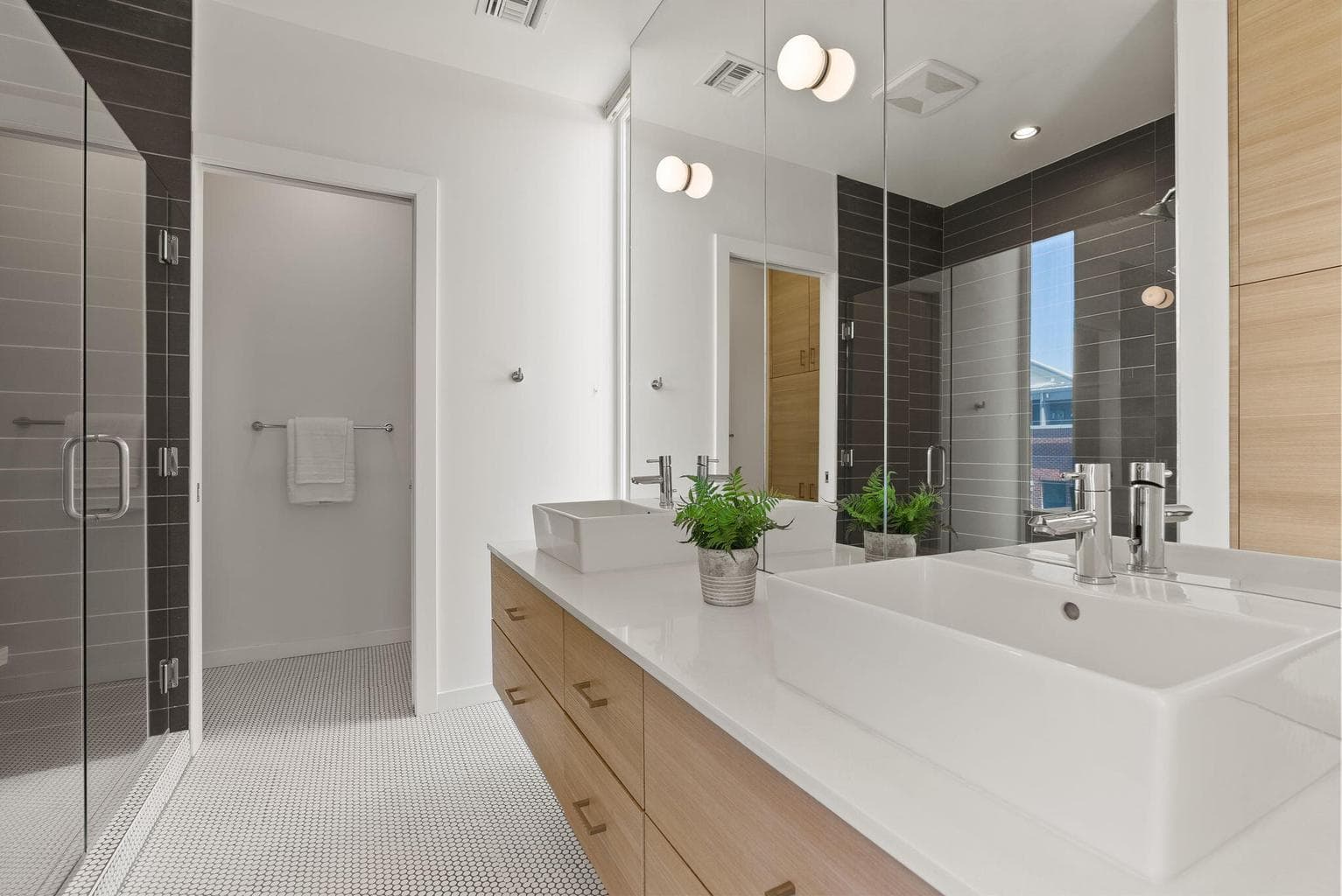 Dual quartz vanity and sleek finishes throughout.