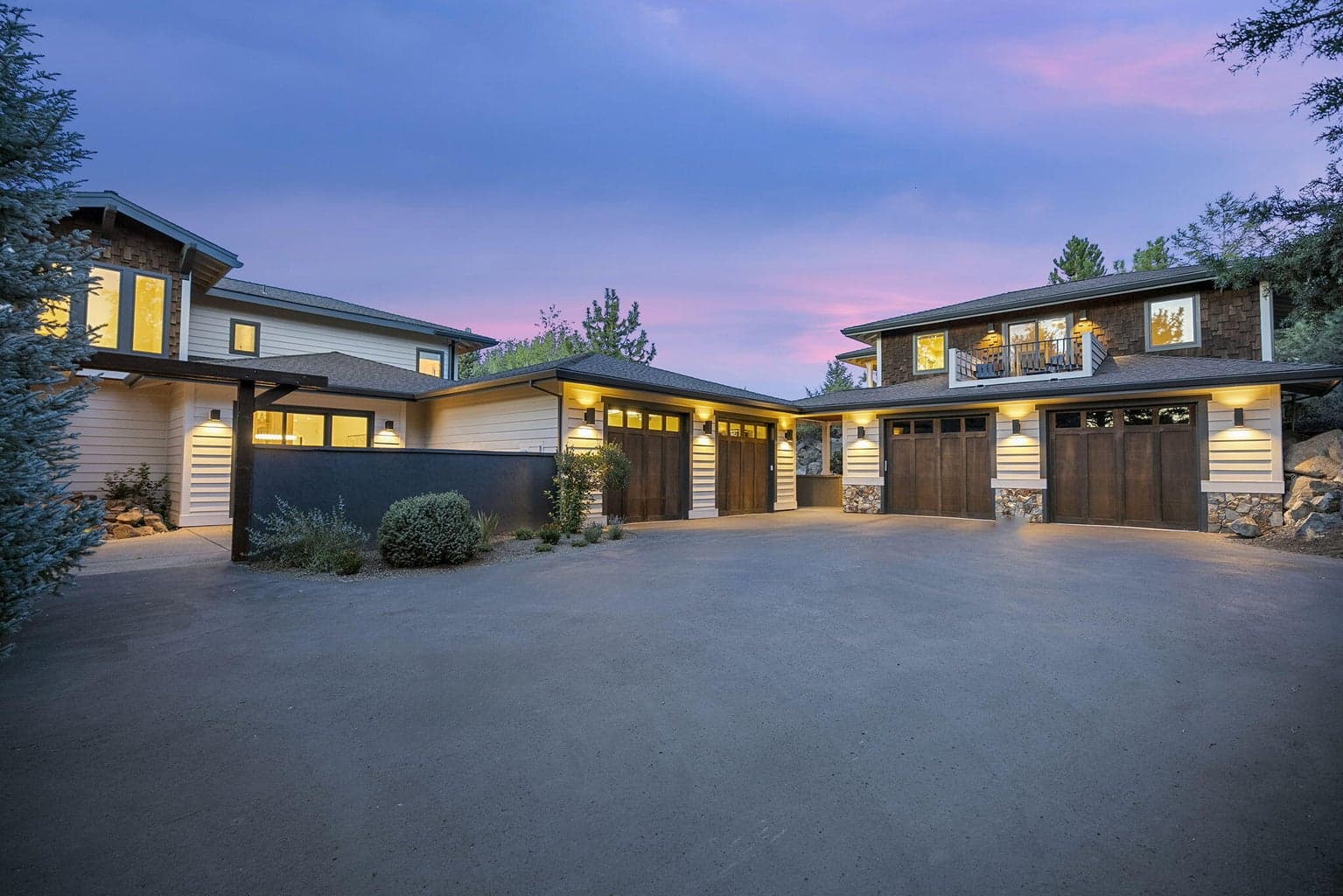 Side of home with 2 garages for 4 cars and a detached ADU