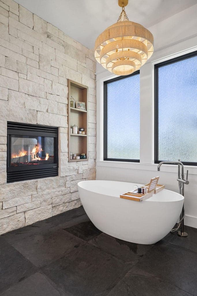 Dual sided gas fireplace with limestone surround
