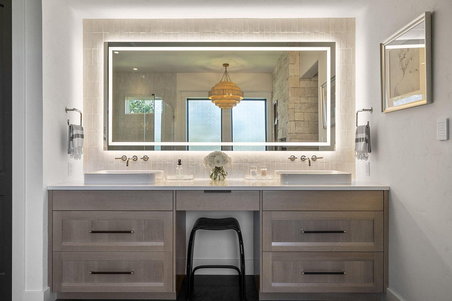 Front and backlit custom made Hollywood mirror surrounded by timeless Ann Sacks tile