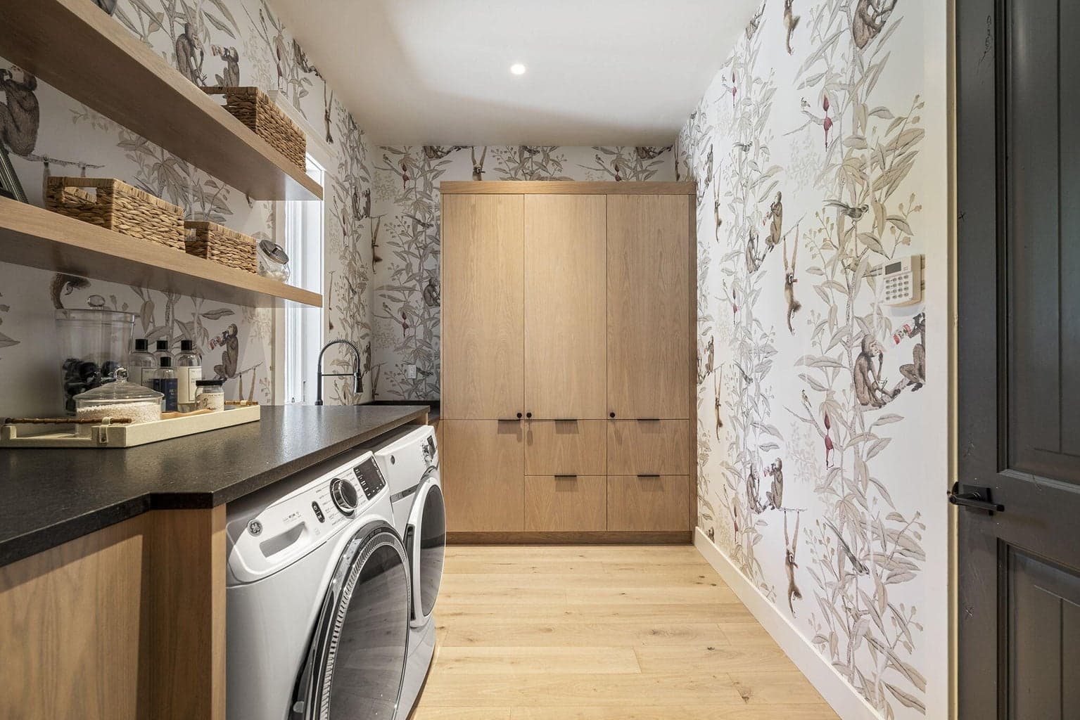 Custom built in cabinets, floating shelves, and look closely at the wallpaper when you tour