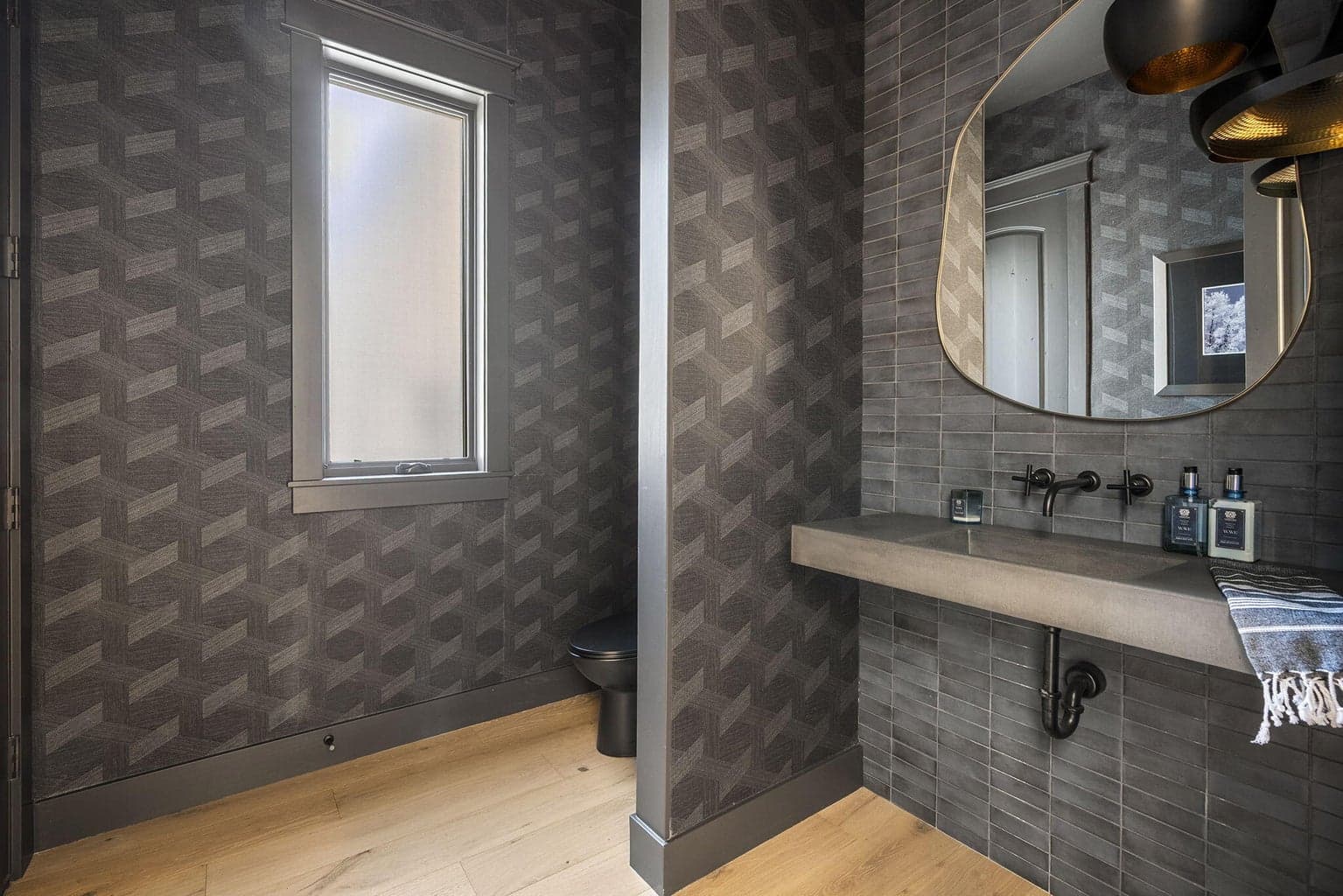 Lower level powder room with custom Cement Elegance floating, integrated sink