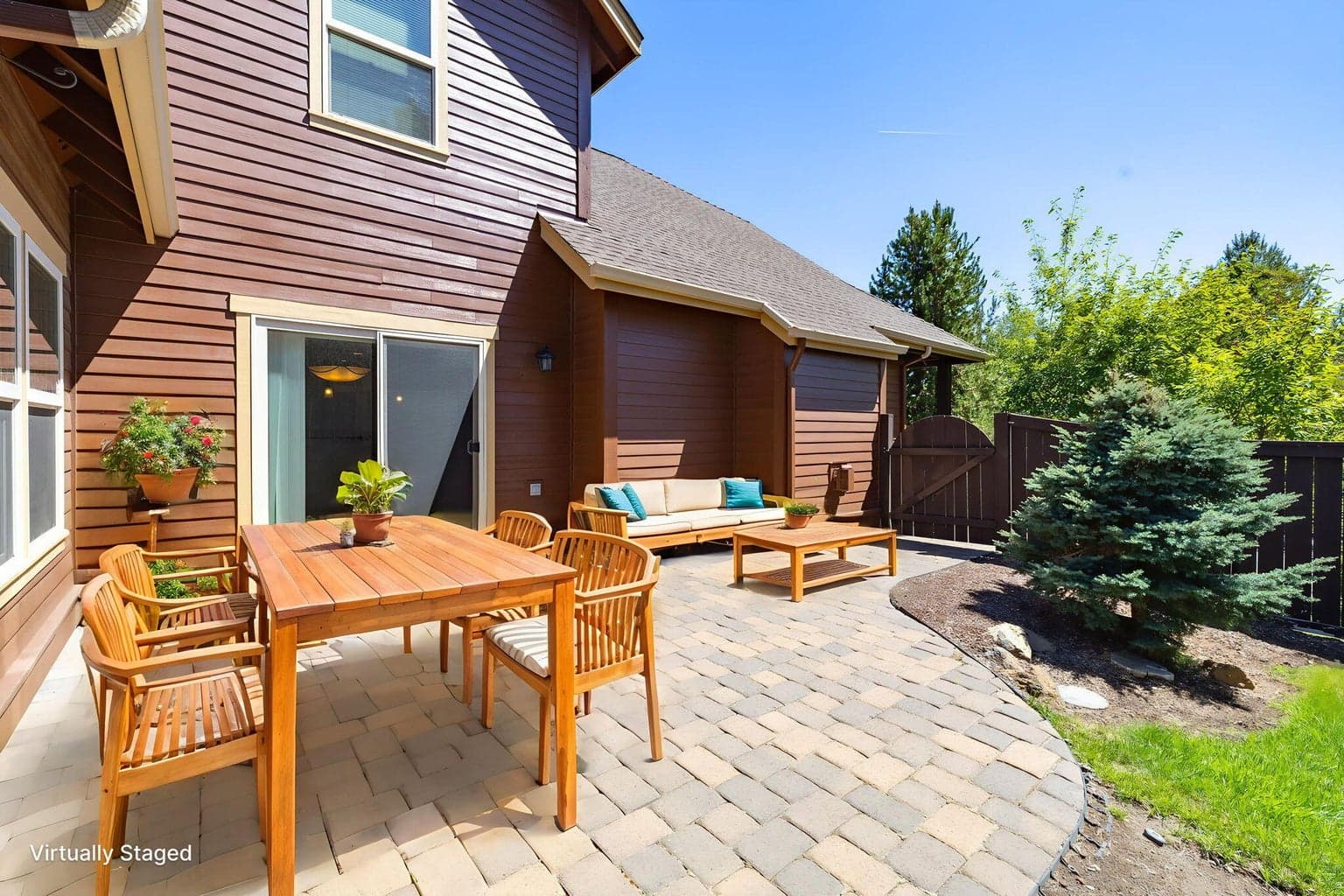 Paver patio in the fully fenced backyard.