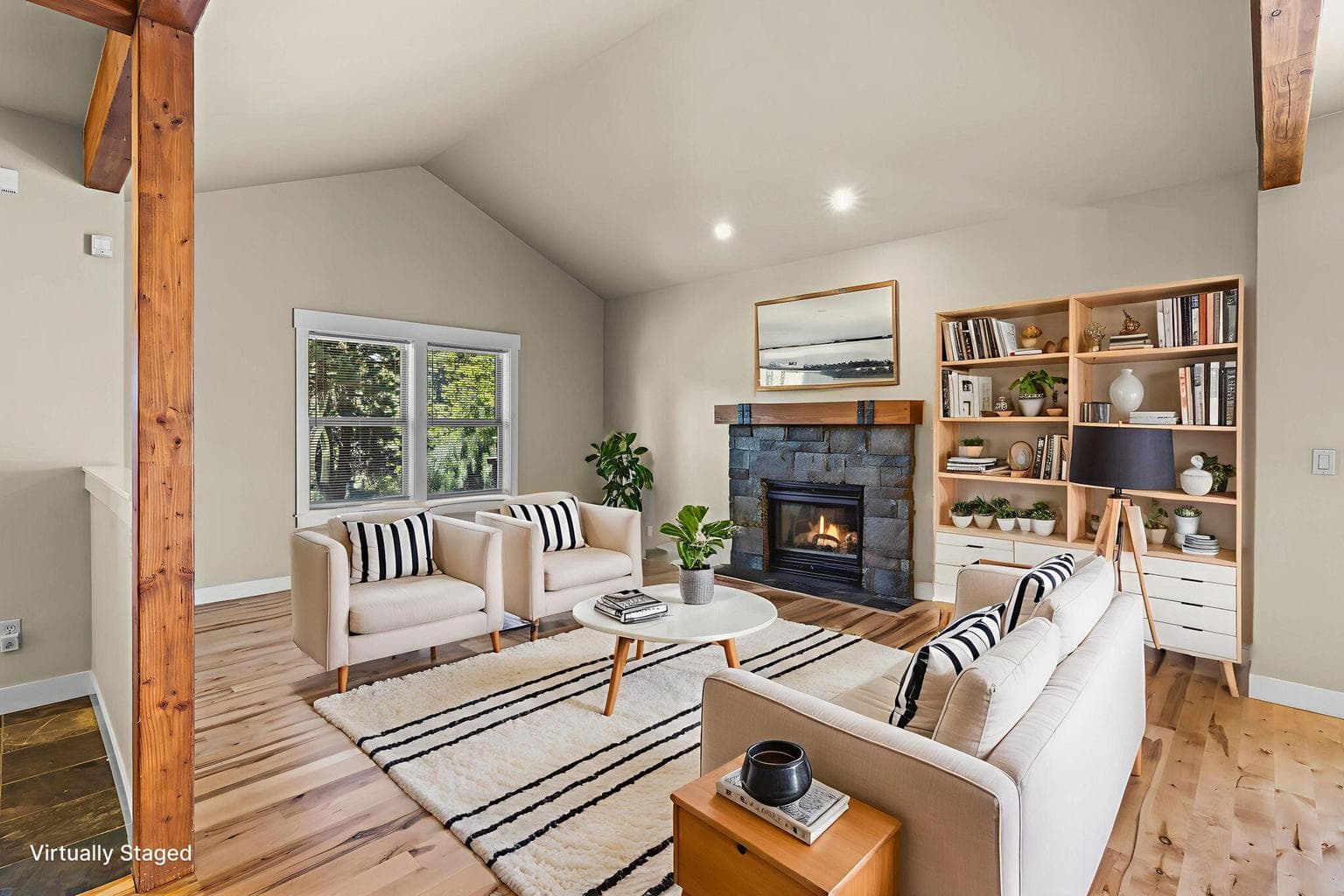 Living room highlights include soaring vaulted ceilings, hardwood flooring & gas fireplace.