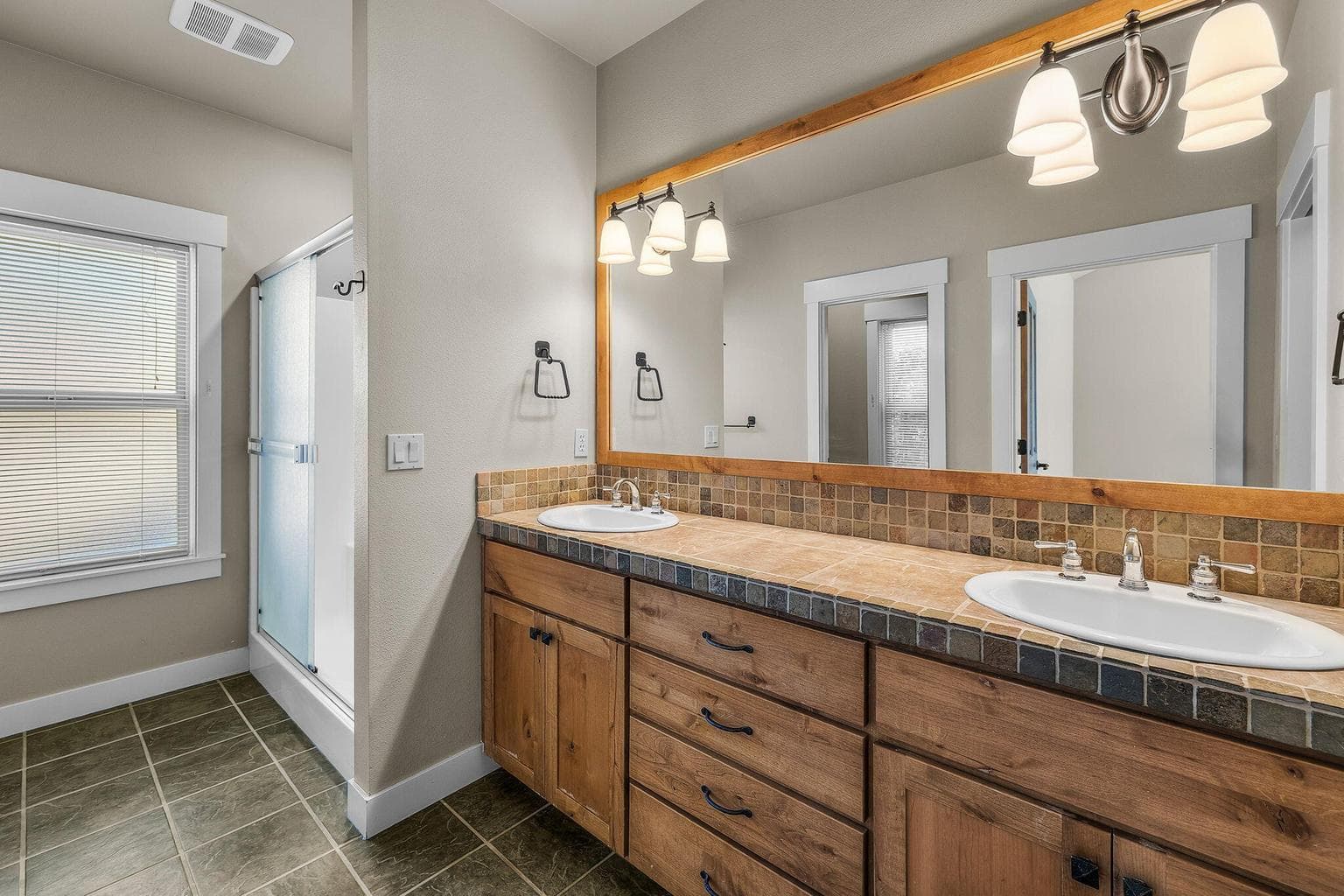 Primary bath includes dual sinks, large shower and walk-in closet.