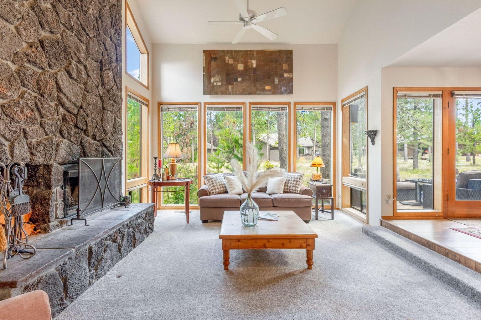 Living room with classic Sunriver wood burning fireplace and tons of natural light