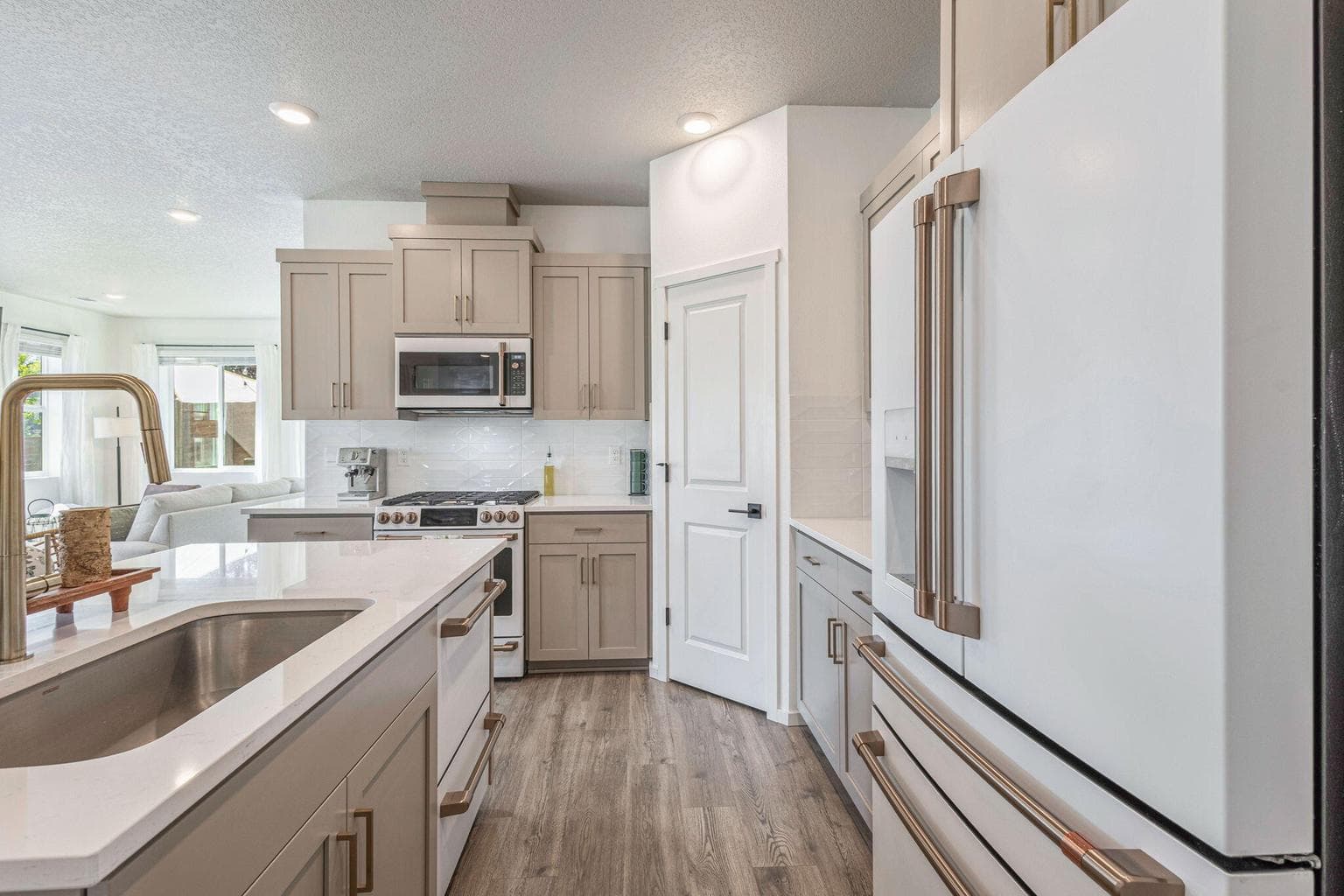 These high end appliances, gold hardware and quartz counters make for a beautiful and functional space!