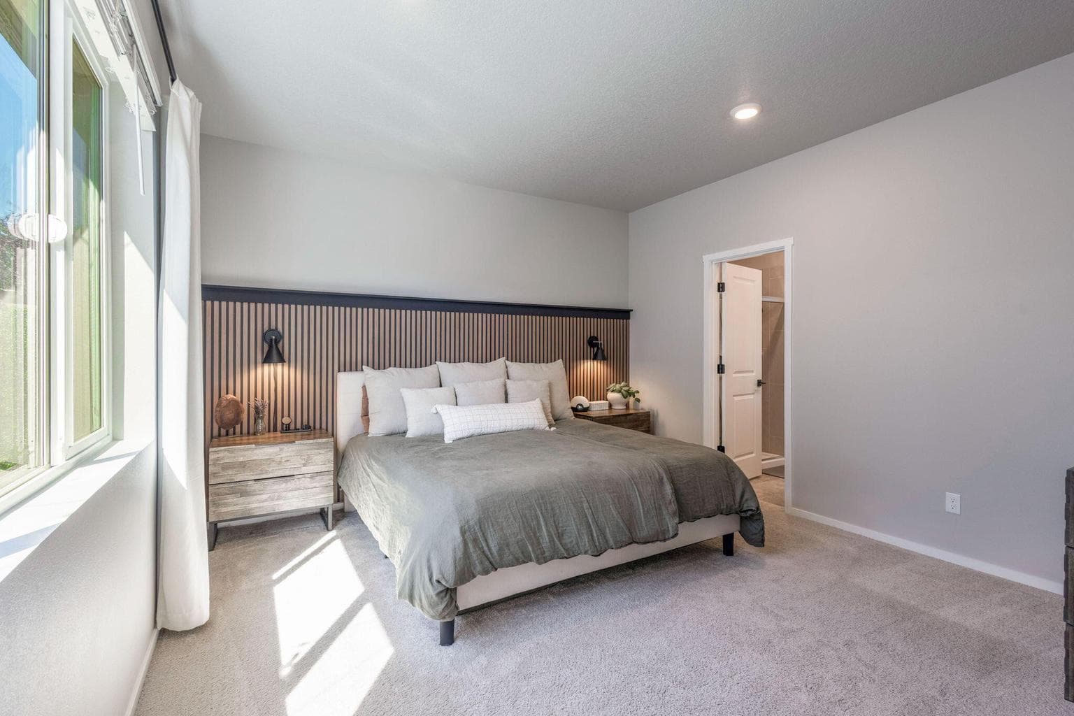 Sits at the back of the home, away from other bedrooms.