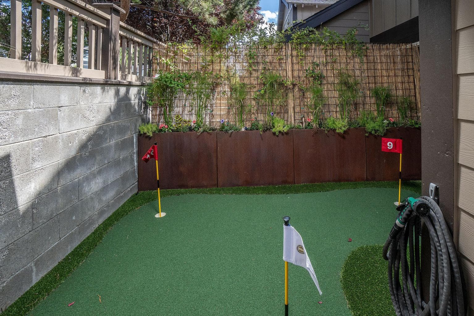 The side yard has a grilling area and a putting green, hours of entertainment for the golfing enthusiast.