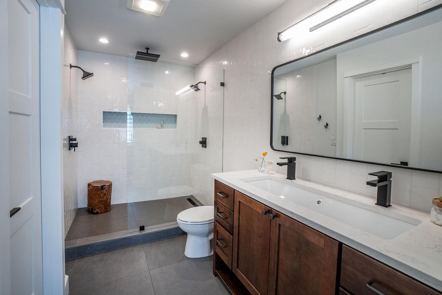 Primary bath with double headed tile walk in shower and dual sinks. Feels very luxurious!