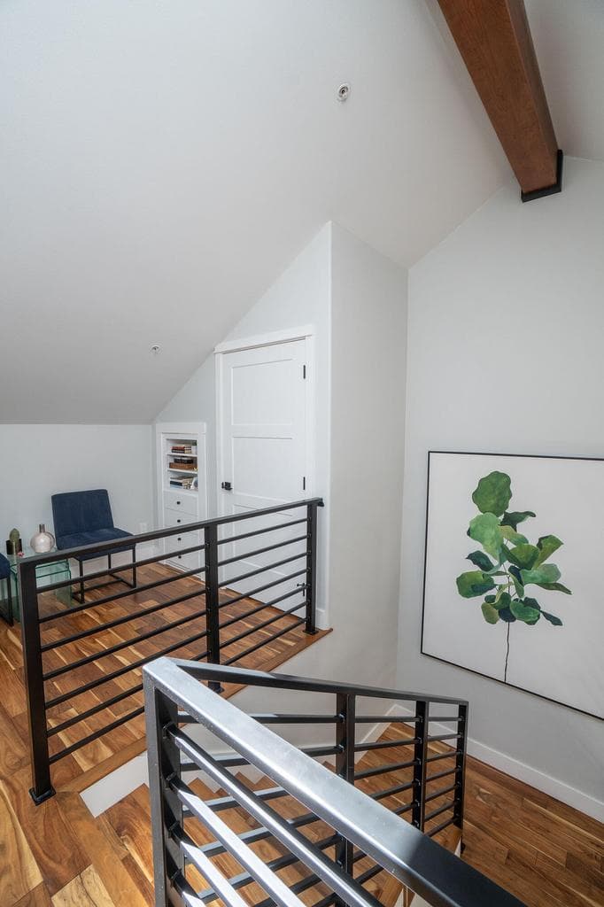 Wood flooring and railing continue upstairs adding to that open feel.