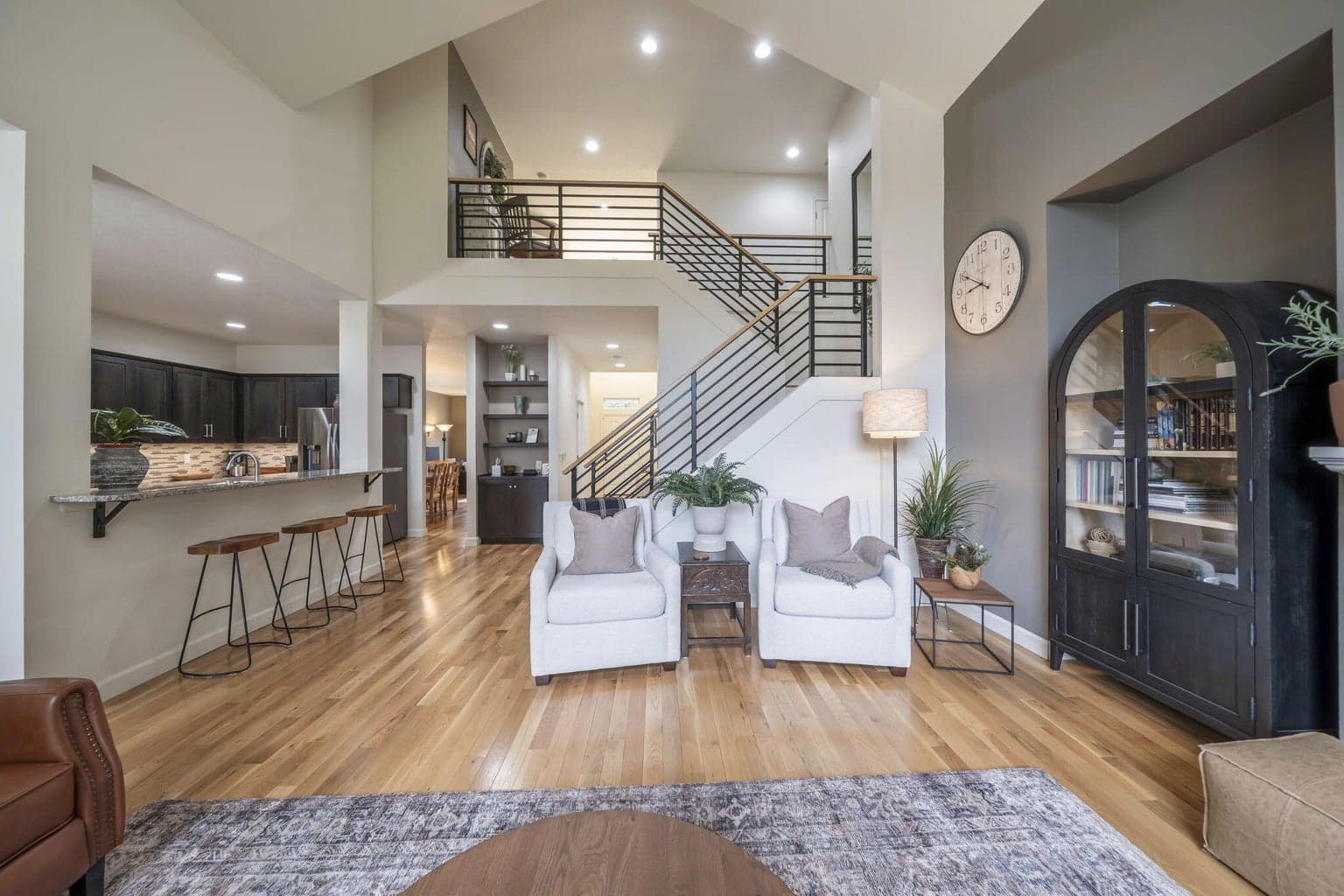 The stairs are 3/4 " solid white oak and it is perfectly paired with custom black steel railings that are capped with white oak.