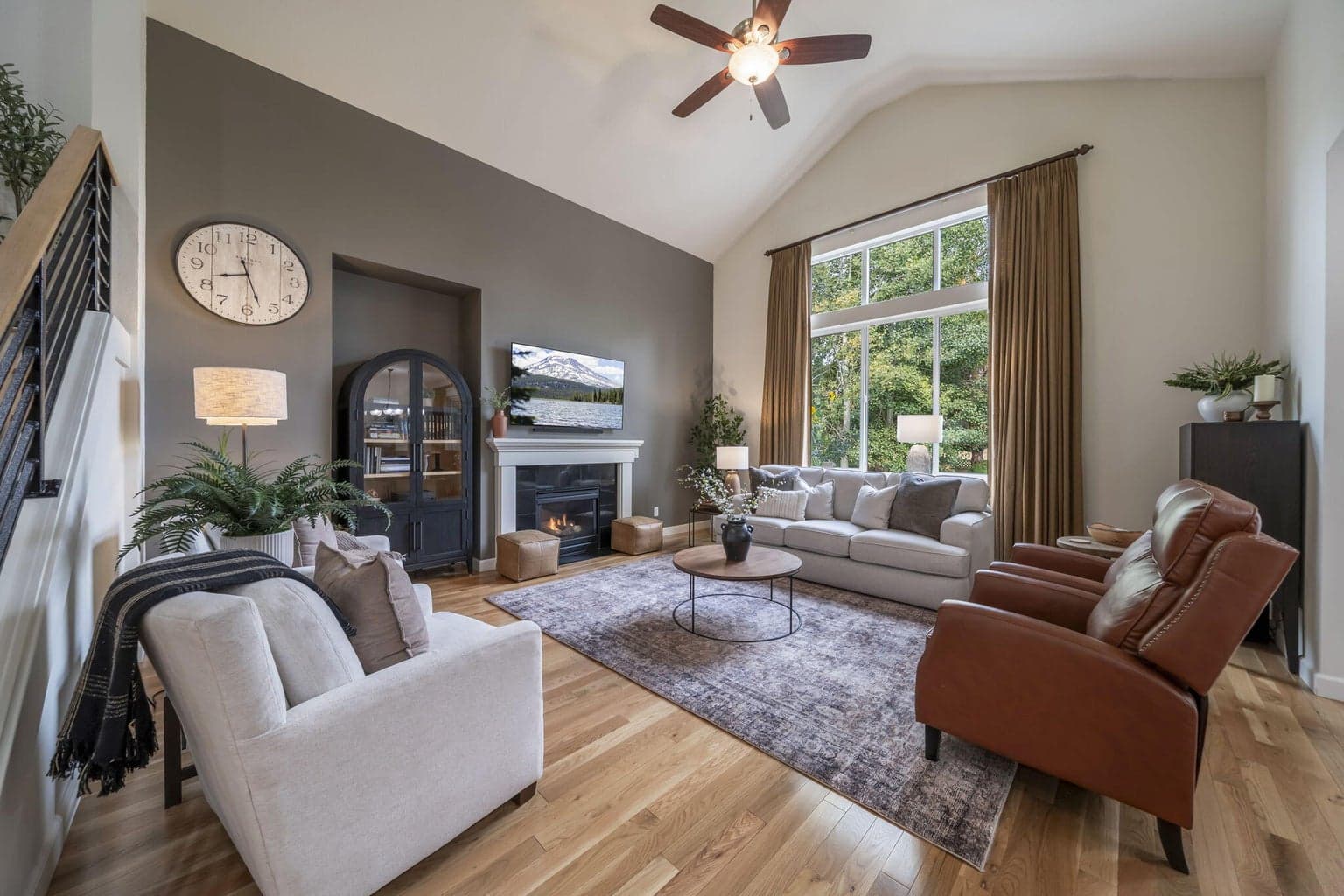 This family room features floor to ceiling drapes, 3/4 " solid white oak floor, and a mood setting gas fireplace.