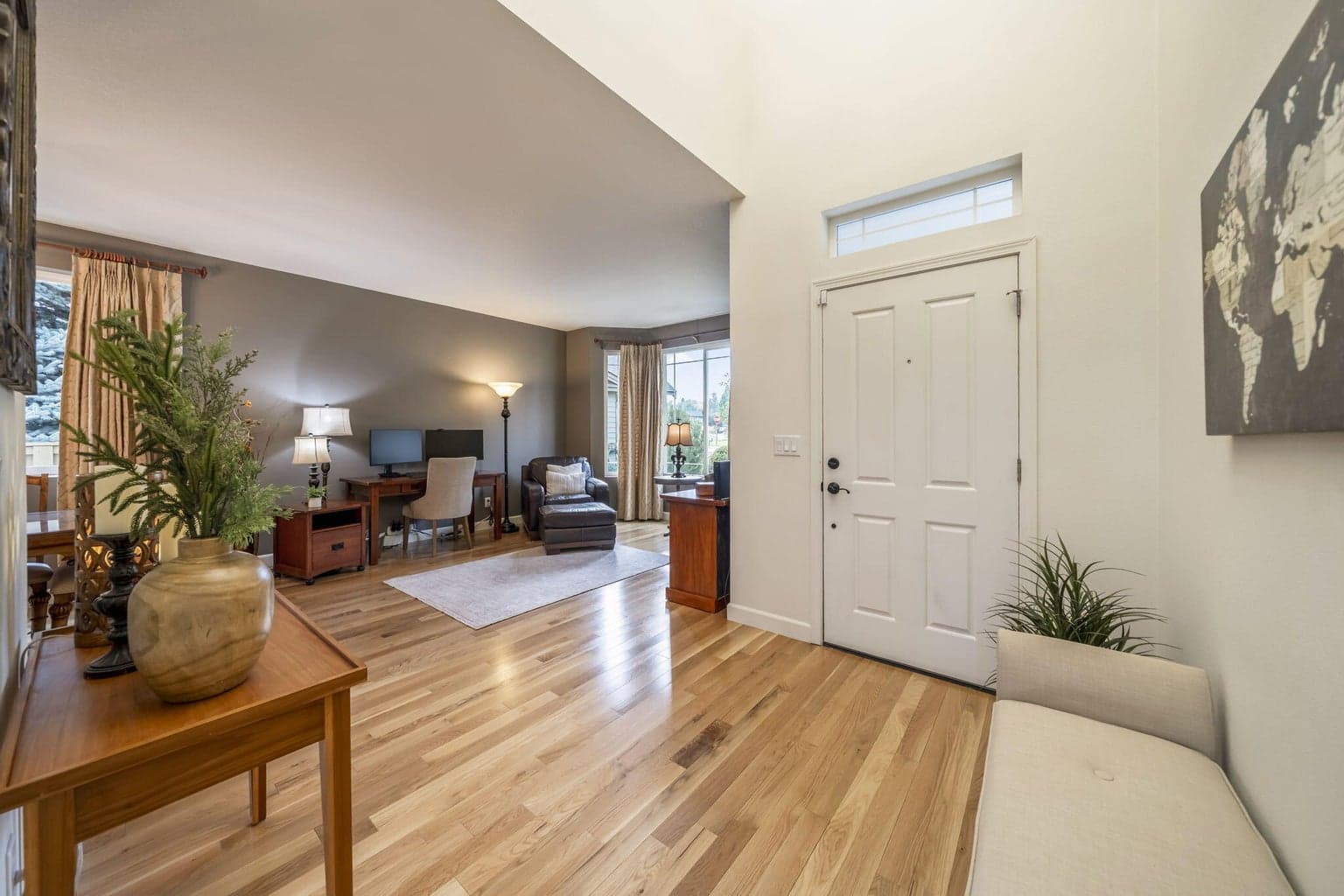 The front entrance has plenty of space for a bench that the door is accented with a transom window. The solid white oak floors run throughout the entire first floor.