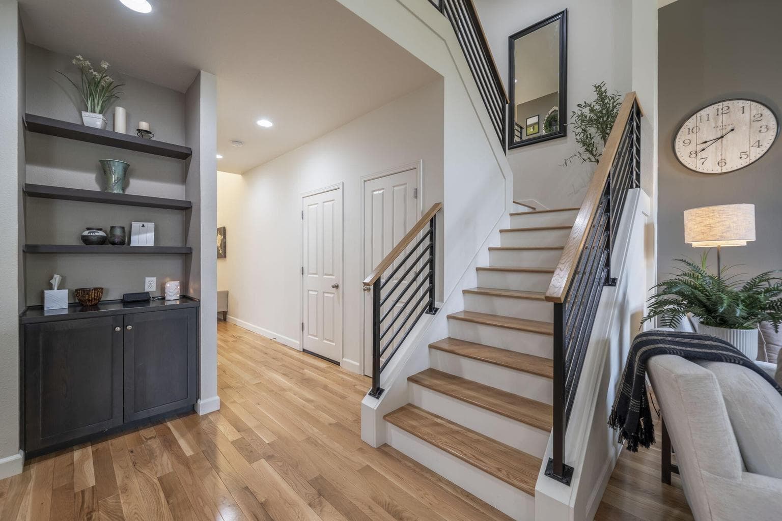 A great view of the white oak stairs and black steel railing with the white oak cap. It will be even more captivation when you see it in person.