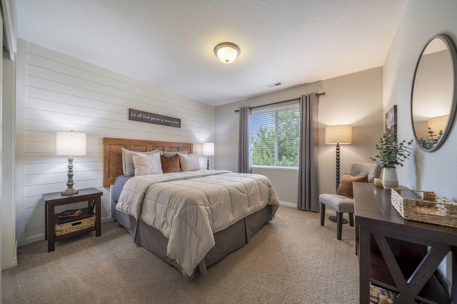 This guest bedroom has been accented with a shiplap wall.