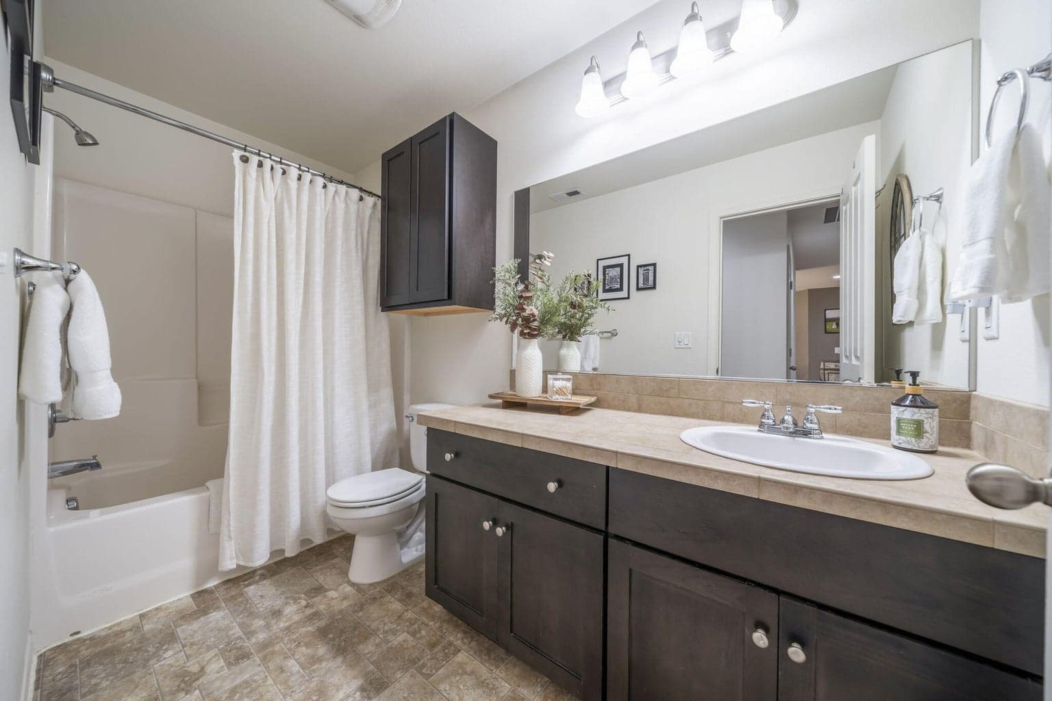 The upstairs guest bath has a long vanity for extra storage.