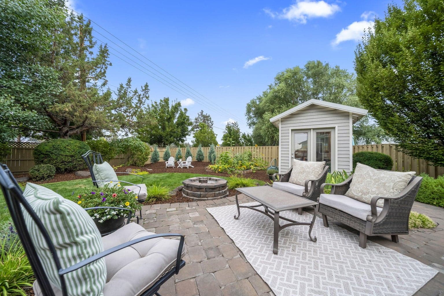 The paver patio is just down from the deck. You can see the fire pit at the end of the paver patio. There is about a cord of split and stacked wood for the fire pit that comes with the house!