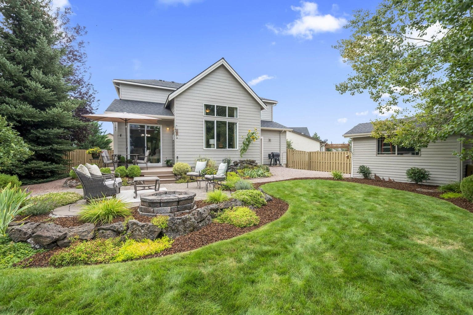The professionally landscaped yard has flowers the will bloom throughout the growing season..