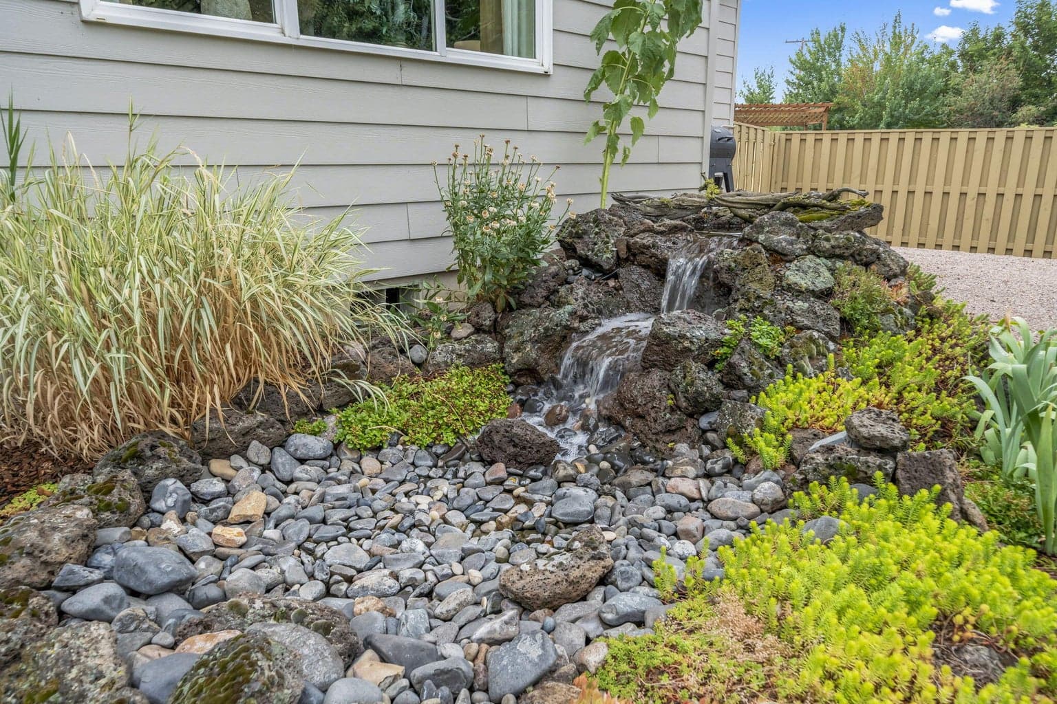 The water feature is the soundtrack for this dreamy backyard.