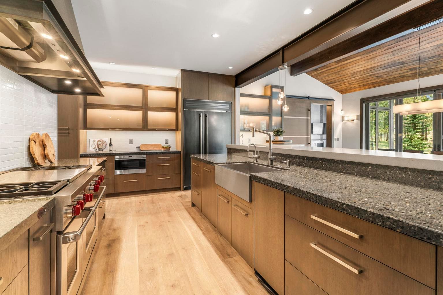Spacious pantry & striking custom steel trim elements including Sub Zero panels & hood.