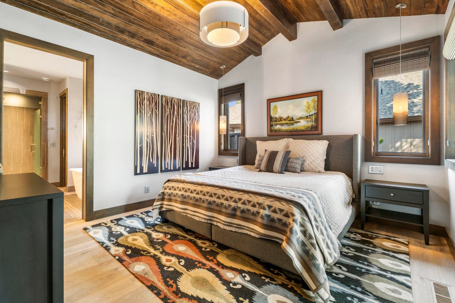 The main level offers radiant floor heat, a spa-like primary suite with steam shower, and even exterior shower walls w/ radiant heat.
