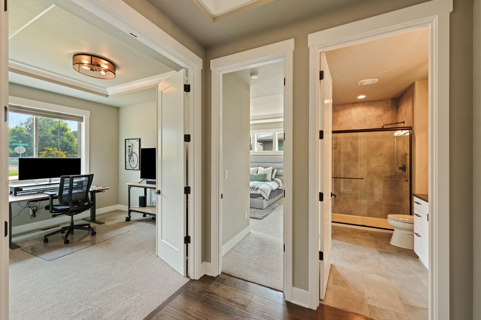 Private office near entry, entrance to guest suite with access to guest bathroom in hallway